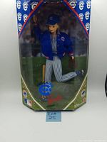 Front view of vintage Chicago Cubs Barbie doll in original unopened box, showing doll in Cubs blue jacket and striped pants.