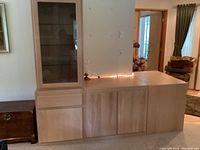 Overall L-shaped arrangement of four blond oak cabinets against wall