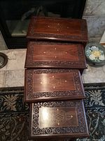 Overhead view of four rosewood tables nested together