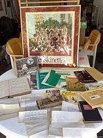 Photo of the entire lot laid out on a table including the framed Redskinettes photograph, various letters, postcards, sheet music, and books.