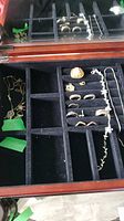 Wooden jewelry box tray showing all necklaces, pendants, rings and earrings
