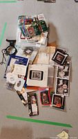 Overview of all cross stitch pattern kits and charts laid out showing variety of holiday themes and some sealed kits