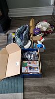 Overview of lot including boxes containing various crafting materials, yarn, knitting needles, fabrics, and frames.