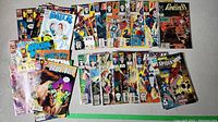 Overview of approximately 30 assorted Marvel comics including The Punisher, Spider-Man, Flash, Green Lantern, Hulk, and others arranged in two rows showing cover art.