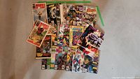 Full view of assorted comics spread on floor, showcasing various Marvel titles including Spider-Man and Daredevil.