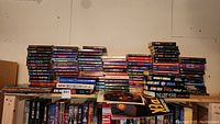 Wide view photo showing large stacks of Star Trek paperback books and some Star Trek pictures.