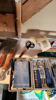 Photo showing wooden-handled tools, scissors, and plastic case with screwdrivers and ratchets