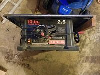 Top view of Craftsman 10-inch table saw showing blade and control panel with branding and power cord.