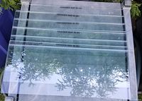 Five flat rectangular glass shelves stacked showing the glass thickness and size markings.