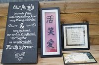 Five framed inspirational message art pieces displayed on wooden surface