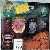 Front cover of King Crimson 'In the Wake of Poseidon' LP album with illustrated artwork and promotional yellow sticker.