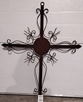 Full view of the wrought iron Fleur De Lis wall cross against a white background, showing the full decorative design and dimensions.