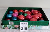 Box and tray of assorted colorful glass Christmas tree balls.