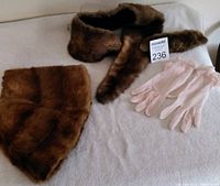 Image showing two brown vintage fur coat collars and a pair of vintage pink sheer gloves on a white surface with lot number.