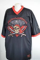 Front view of black mesh Pirates of the Caribbean jersey with large embroidered skull and crossed swords and red trim on collar and sleeves.