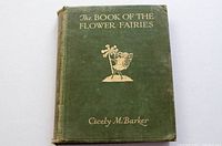 Front cover view showing green cloth hardcover with gold embossed title and fairy illustration
