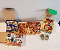 Overall view of unopened baseball card packs from various brands on a white table.
