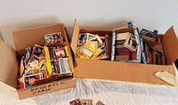 Two large cardboard boxes filled with mixed loose baseball cards from the 1980s, majority appear to be Topps brand with some other brands mixed in.