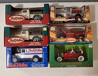 All six collectible diecast toy banks in original boxes arranged together showing branding and model details.