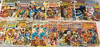 Overview of 14 Fantastic Four and Marvel's Greatest Comics comic books with colorful cover art, plastic protective sleeves visible on some.