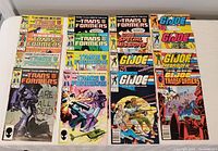Wide view of 18 Marvel comics laid out in two groups, half are Transformers comics, half are G.I. Joe comics.