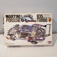 Box art of Tamiya Martini Porsche 935 Turbo 1:12 scale model kit showing Martini Racing livery and cutaway design drawing