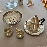 Photo showing the vintage royal Holland pewter teapot, creamer, sugar bowl on the Bristol silverplate tray, and the pierced pewter bowl.