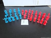 Full lot of 47 Star Wars mini hologram figures displayed on black surface, showing 30 red and 17 blue figures in rows.