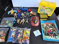 Full view of all items included in lot arranged on black table surface.