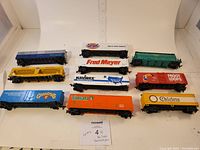 Top view of all 10 HO scale railroad cars arranged in 2 rows showing brands and colors