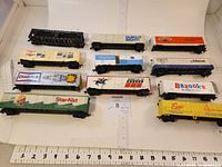 Overview of 11 HO Scale model railroad freight cars showing variety and scale with ruler.