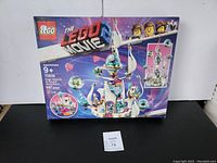 Box front image showing LEGO Movie 70838, set piece count, age recommendation, and illustration of the completed space palace with minifigures.