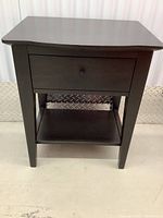 Front view of the wood night table showing drawer and lower shelf