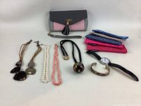 All items displayed together showing full lot contents including jewelry, wallets, watch, and purse.