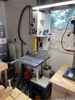 Front view of Rikon 10-324TG 14" bandsaw on included base showing table and blade