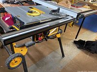 Angled view of table saw top showing miter gauge slot, fence and extension wing
