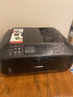 Front view of Canon Pixma MX712 printer showing control panel and device top.