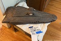 Full view of carved wooden crocodile head resting on folded cloth