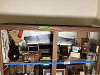 Full view of wooden display cabinet shelf containing all items