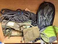 All items displayed together: rope coil, two camo rope bags, Marmot backpack and Adventuridge pack