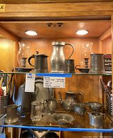 Overall display of pewter items on shelf