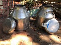Front view of both milk cans with lids removed