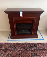 Front view of the Coaster cherry wood electric fireplace showing its overall appearance and condition.
