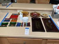 Full lot overview with all decorative servingware items arranged on kitchen counter.