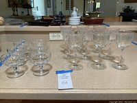 Photo of 6 parfait glasses and 9 wine glasses arranged on countertop, showing overall set quantity and condition