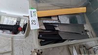 Photo of assorted kitchen knives and cutting tools in plastic bin