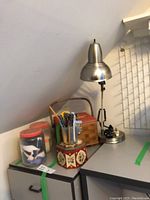 Overview photo showing sewing boxes, spools, tools and sewing lamp arrangement