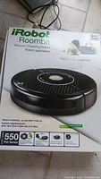 Box front photo showing iRobot Roomba 550 Pet Series vacuum cleaning robot with features and branding.
