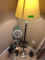 Overall grouping of floor lamp and assorted clocks on the floor