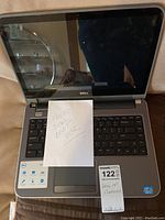 Open Dell 14-inch laptop showing screen with note reading 'NEED DELL BOOT DISK'